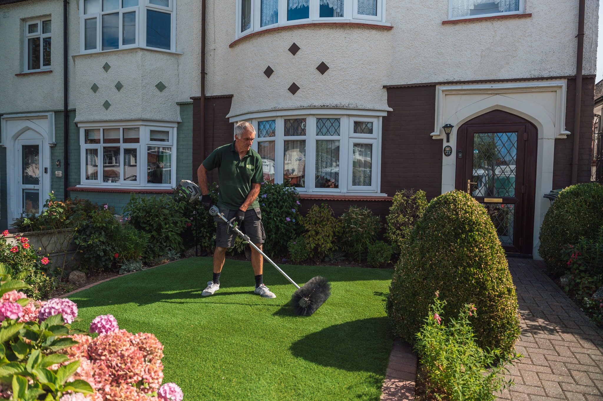 Applying finishing touches to artifical lawn