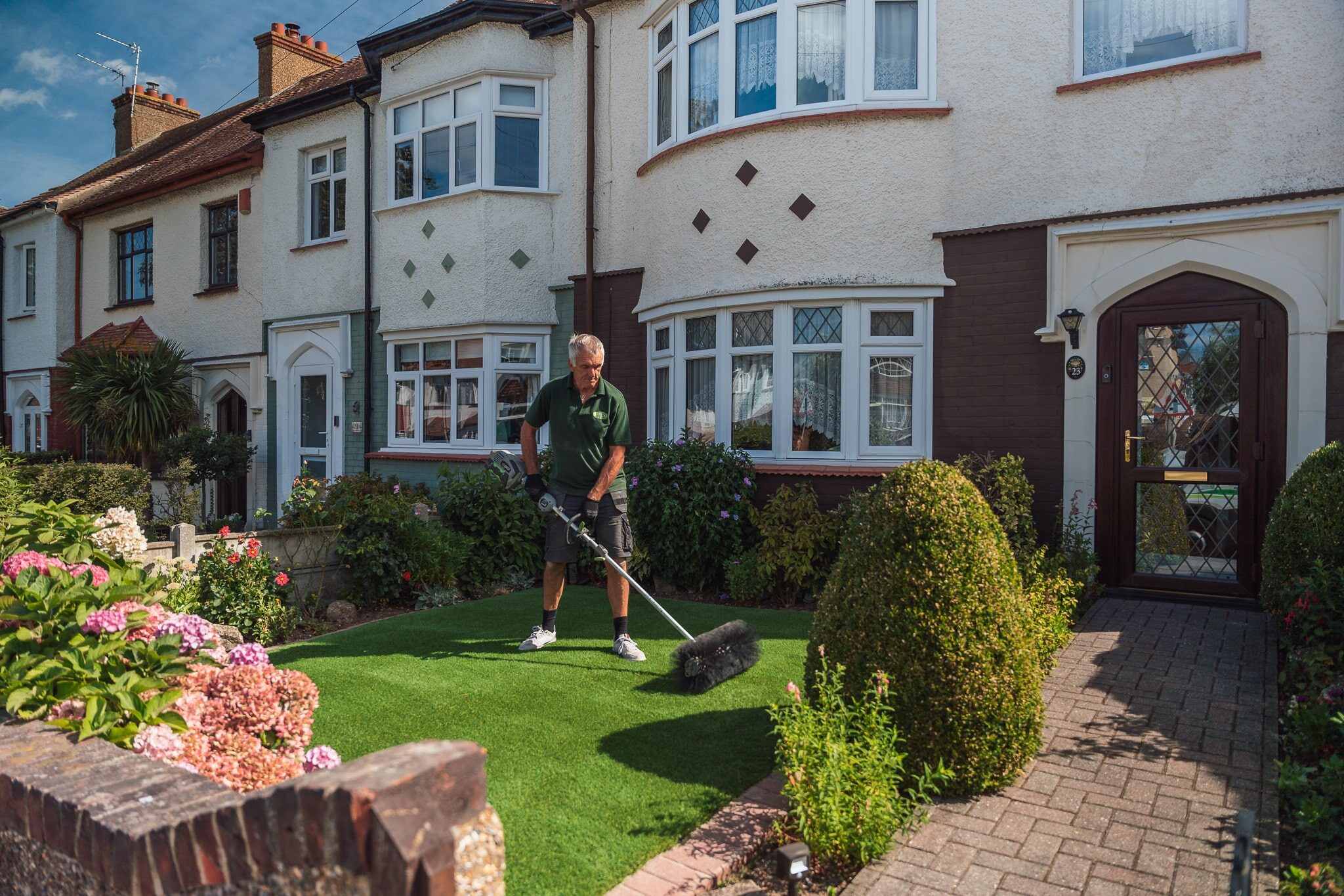 Brushing artificial grass after installation