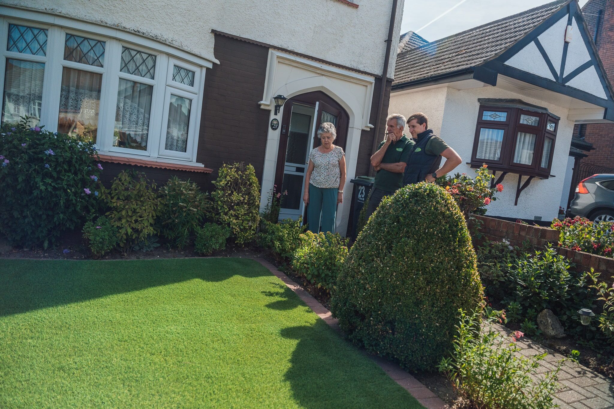 Customer reviewing artifical lawn installation with Artificial Lawn Company