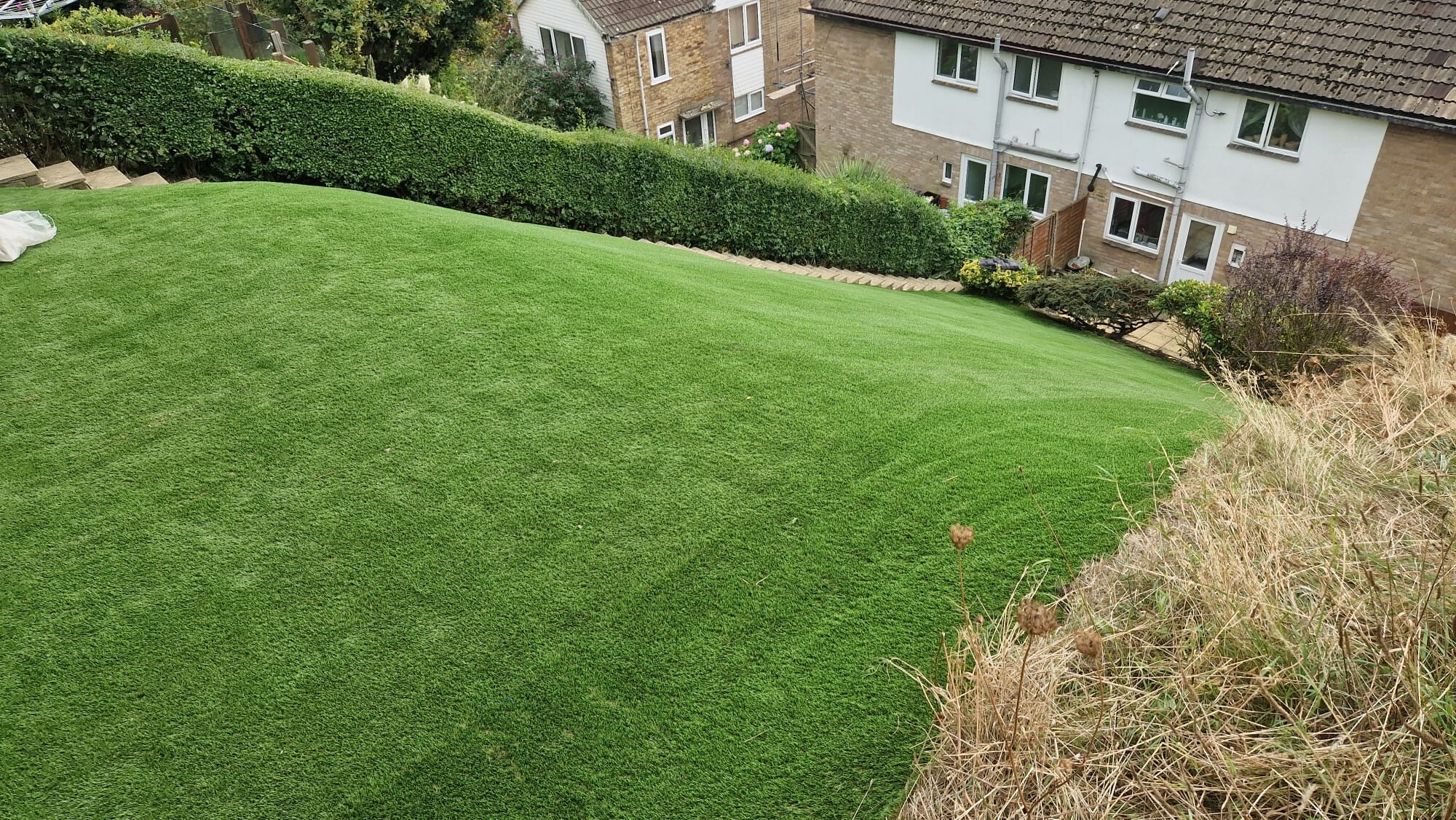 Sloped garden with artificial lawn